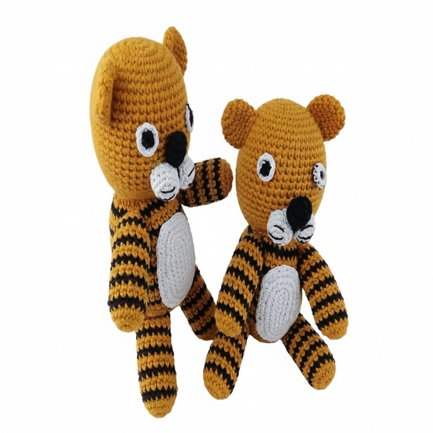 Two adorable amigurumi tiger toys with raised paws in playful pose on white background