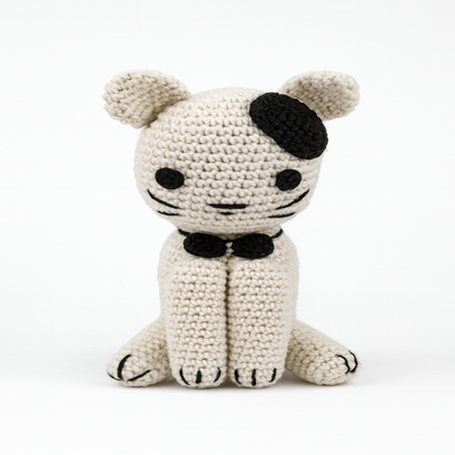 Close-up front view of a crocheted kitten, showcasing the neat 'V' stitches of the amigurumi technique, pointed ears, and a perfectly centered face.