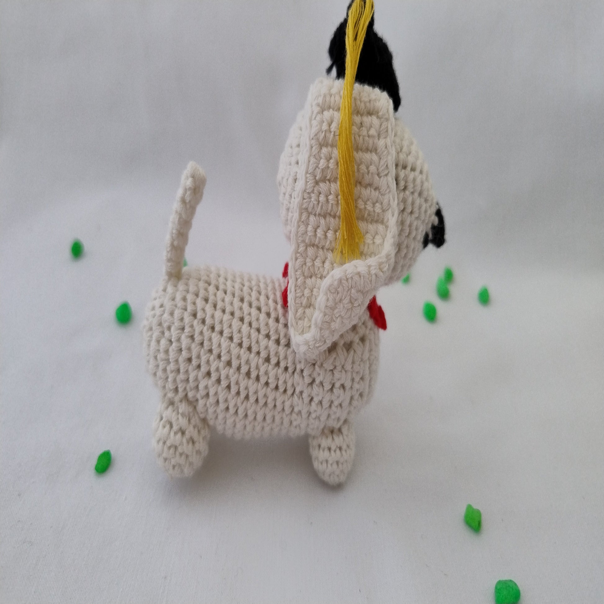 Handmade crochet graduation dog amigurumi side view showing detailed stitching