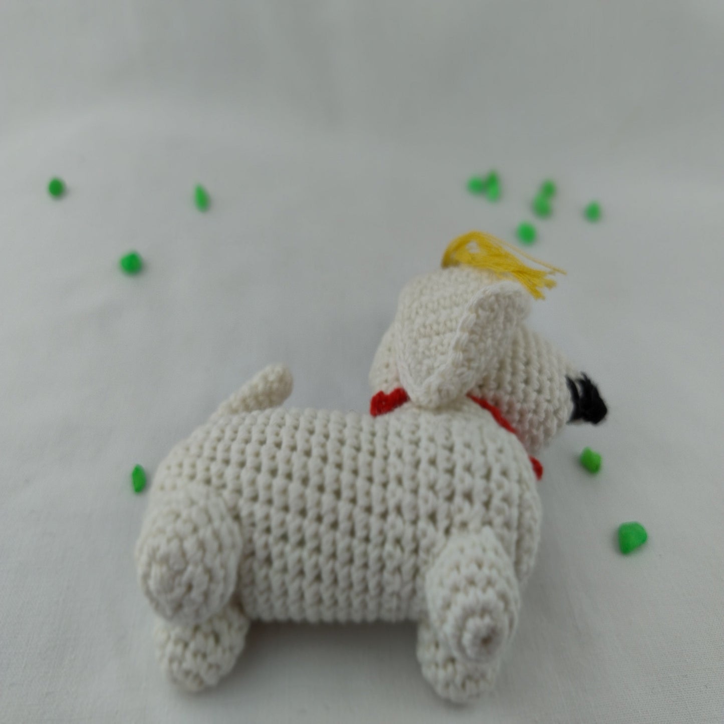 Handmade crochet graduation dog amigurumi side view showing detailed stitching