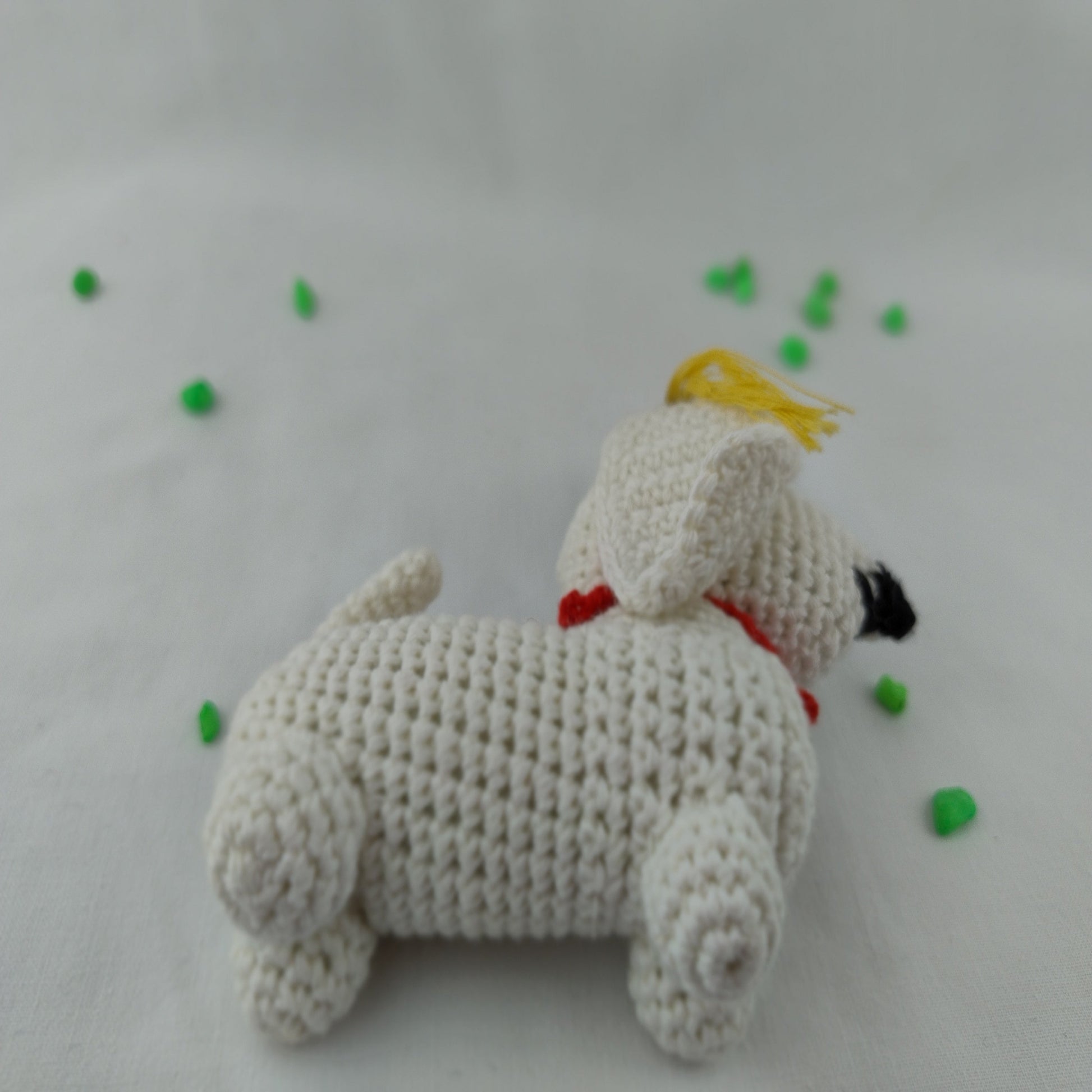 Handmade crochet graduation dog amigurumi side view showing detailed stitching