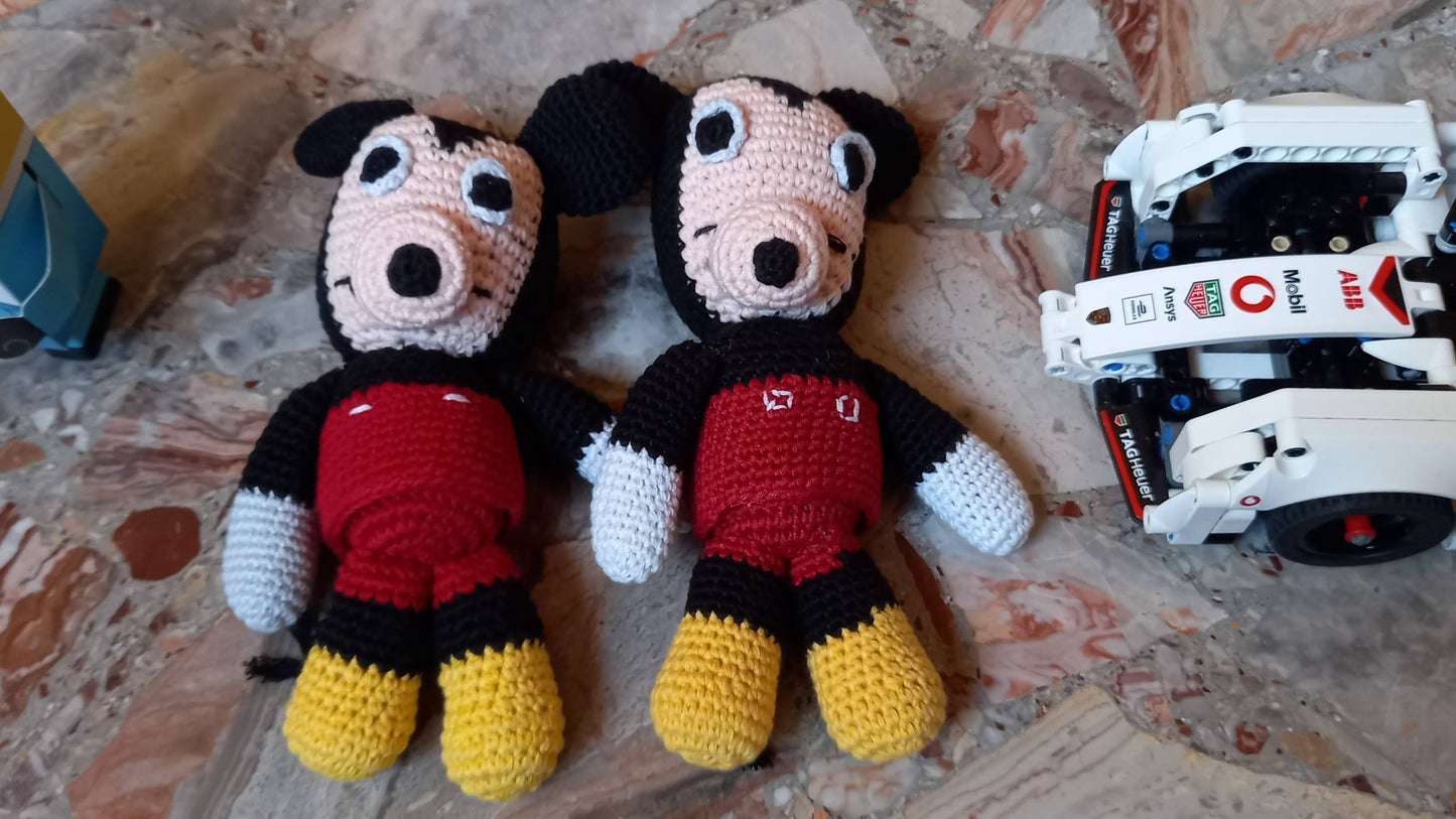 A lifestyle view of two handmade mouse amigurumi toys in a nursery, shown next to building blocks and a toy car; highlighting part of a cozy child's play area