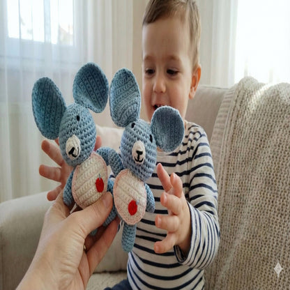 A mother gifting two handmade koala amigurumi to her young son, showcasing soft artisanal toys made in Italy by Cepaale