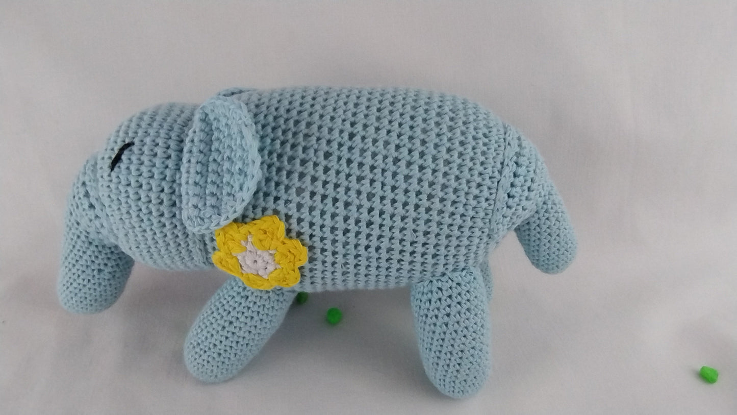 Side profile of a light blue handmade crochet elephant toy