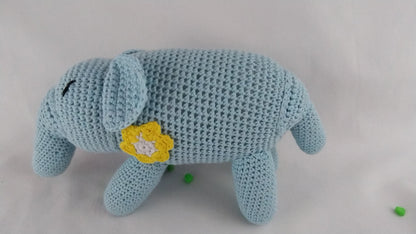 Side profile of a light blue handmade crochet elephant toy