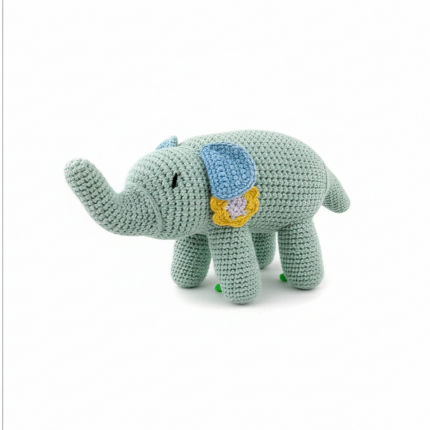 Mint green crochet elephant plush with a yellow flower detail