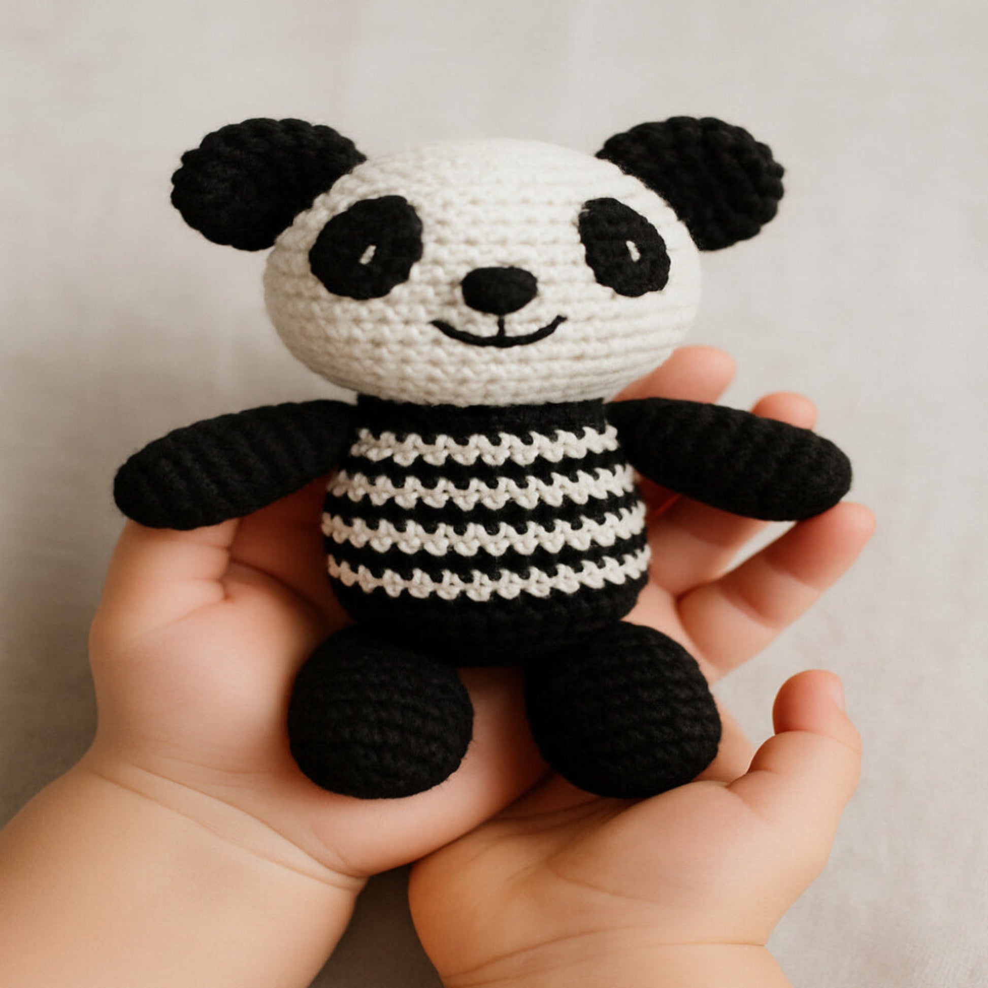Handmade crochet panda amigurumi toy with detailed stitching